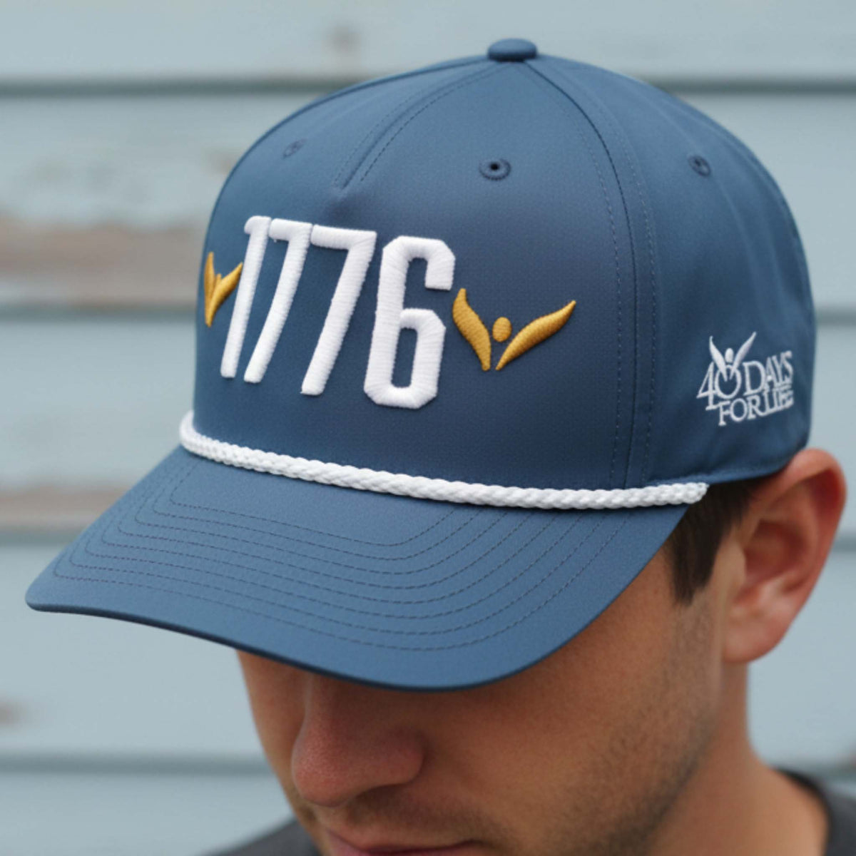 Blue cap with '1776' and '40 Days For Life' logos worn by a person.