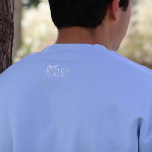 Person wearing a light blue t-shirt with '40 Days For Life' logo outdoors.